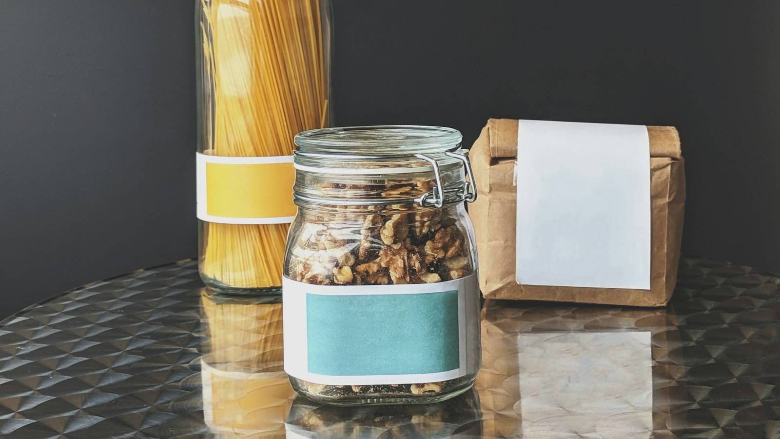 Pasta, a glass jar and a paper pack carrying blank unbranded labels