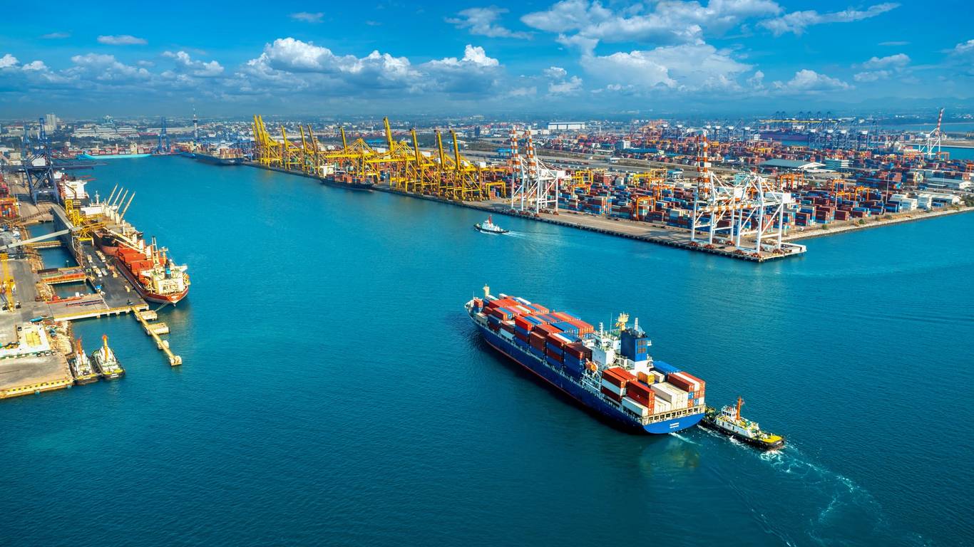 Aerial view of a container terminal with cargo ship and cranes, a US port where Italian food imports arrive
